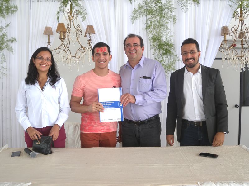 Estudante recebe, simbolicamente, doação de livros da Funesa, através do seu presidente, Adriel Alcântara (à direita)